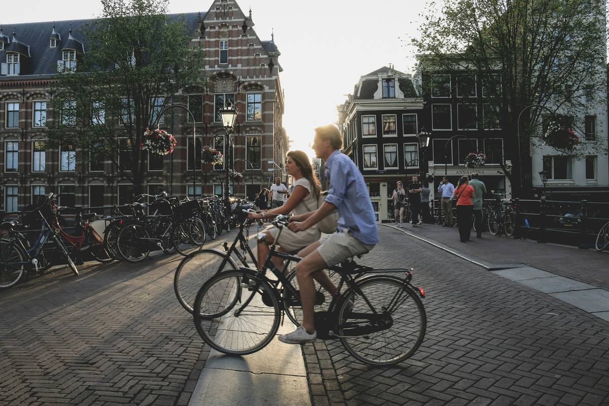 City ebike tour through historic downtown streets with riders smiling near coffee shops