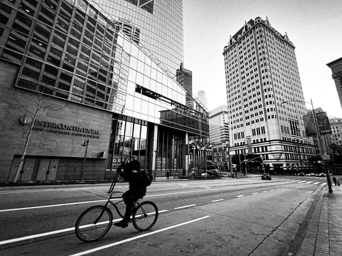 ebike city exploration through downtown streets with riders passing cafes and murals